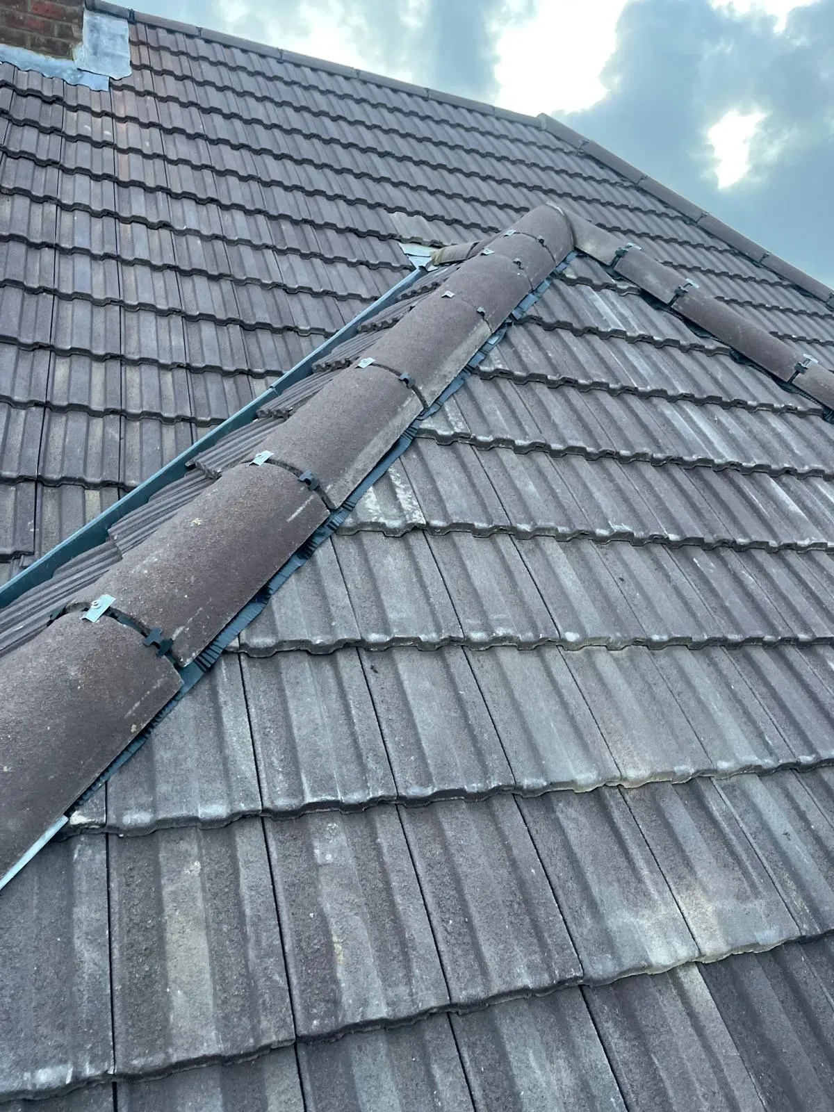 New ridge tiles bedded on a finished roof by Fully Covered