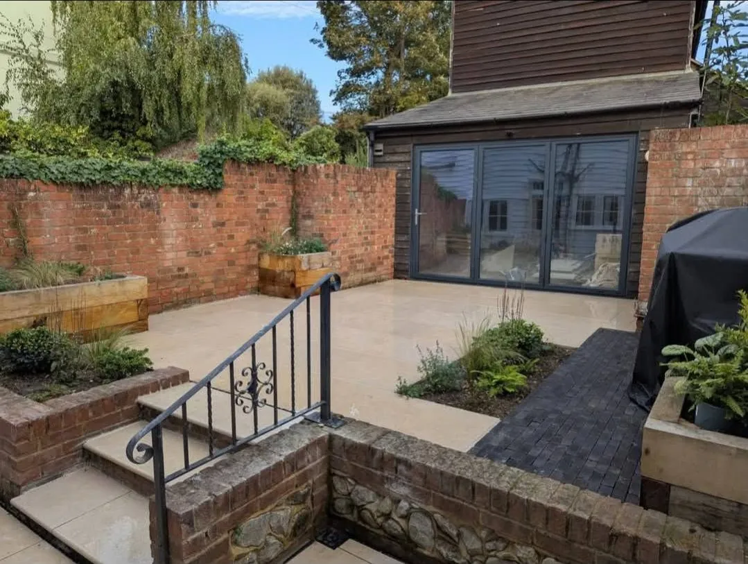 A finished garden by Land & Mortar: raised beds, a patio, steps and a garden room