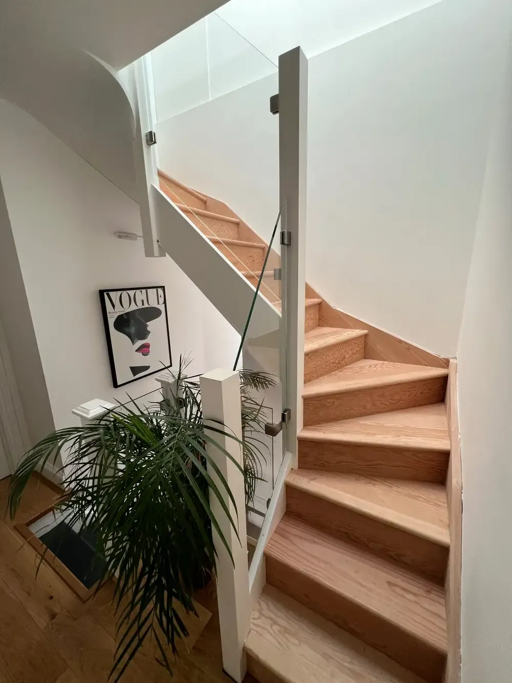 Oak stairs with a glass balustrade by Smithy's Welding Works