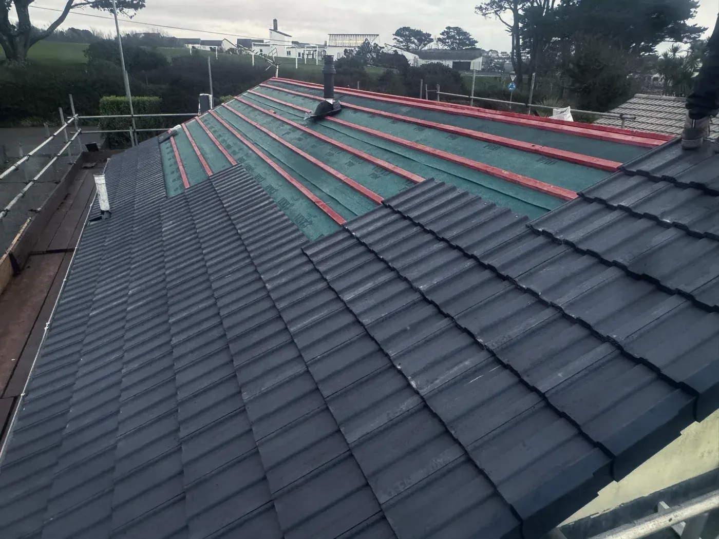 A roof mid-retile by Southridge: new tiles over fresh battens