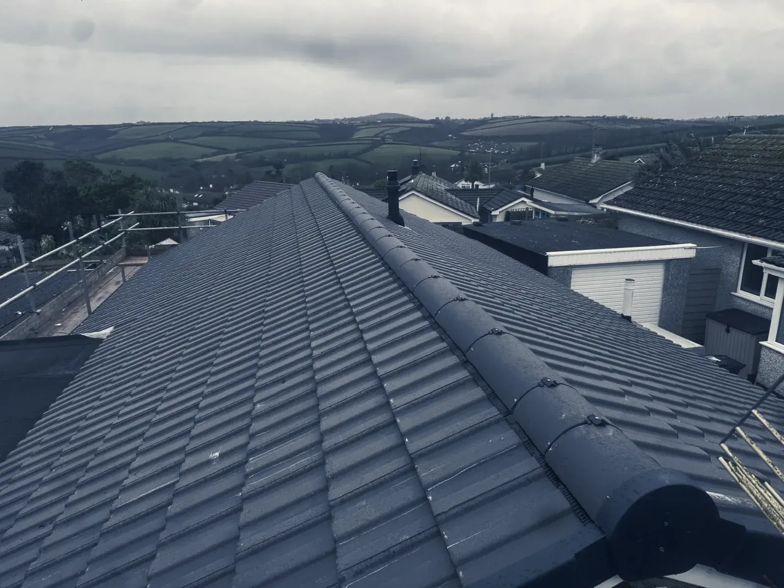 A new tiled roof by Southridge Roofing & Groundworks, hills behind