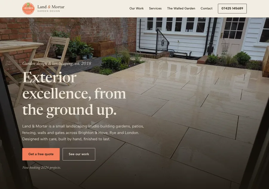 The Land & Mortar homepage, a full-width photograph of a finished patio garden